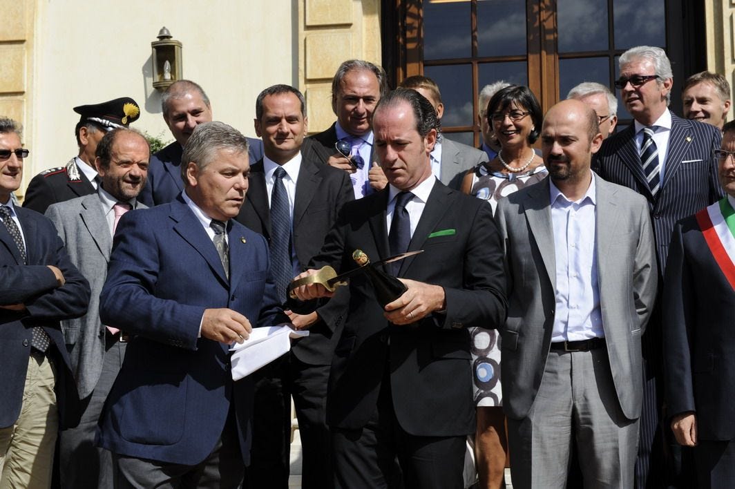 Il ministro Luca Zaia inaugura il Forum tagliando con una sciabola il collo di una bottiglia di spumante (che in realtà era solo incollato). Alla sua sinistra l'assessore regionale Franco Manzato