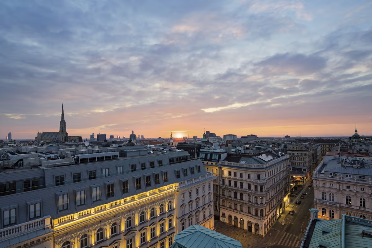 Lo skyline di Vienna si tinge di rosa al tramonto, dominato dalla maestosa guglia gotica del Duomo di Santo Stefano