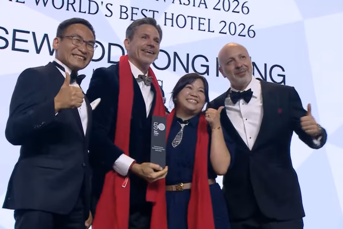 Quattro persone sorridenti festeggiano con un premio durante i 50 Best Hotels