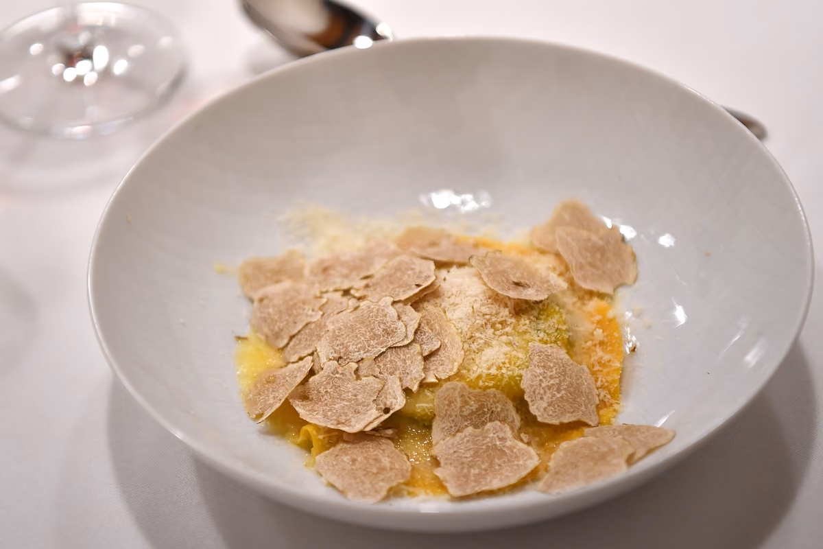 piatto di pasta fresca guarnito con abbondanti lamelle di tartufo bianco