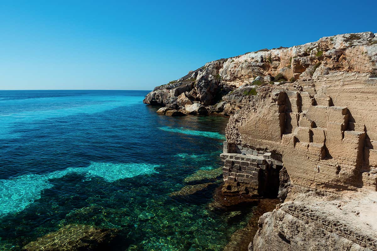 A Cala del Bue Marino, le maestose pareti di roccia scolpite dall'estrazione del tufo creano un paesaggio unico