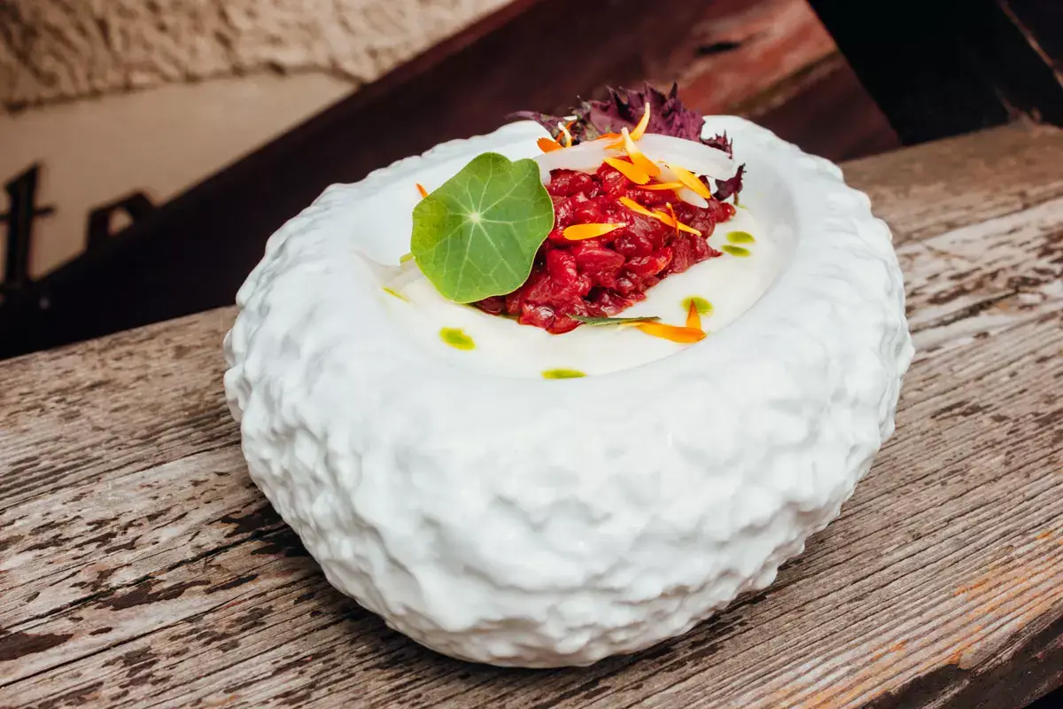 Battuta di filetto di cervo con sedano rapa in crema, olio al levistico, scalogno sottaceto e crescione di ruscello Panna e burro di qualit&agrave; nella cucina della Vecchia Segheria di Pin&egrave;
