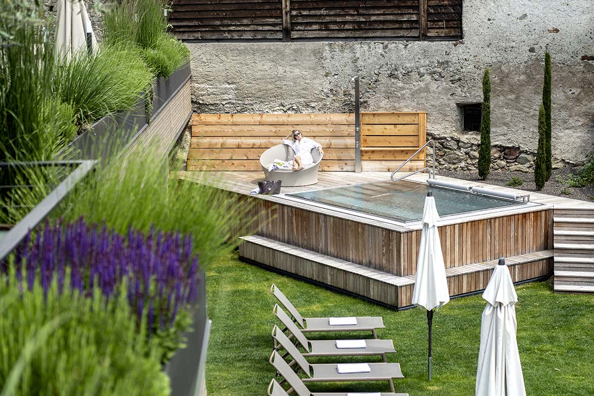 Momenti di relax nella vasca idromassaggio all'aperto dell'hotel, immersa nel verde del prato e circondata dal silenzio della natura