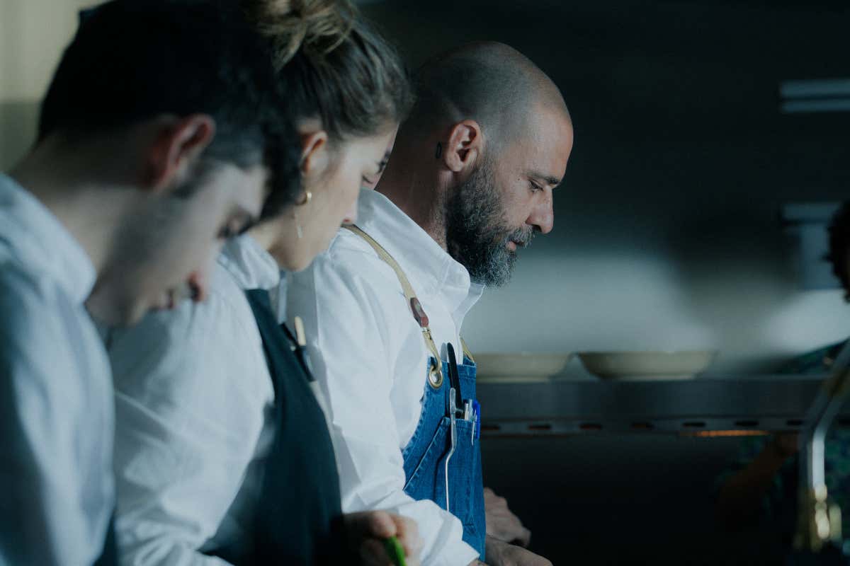 Chef Christian Costardi al lavoro con la brigata di Scatto