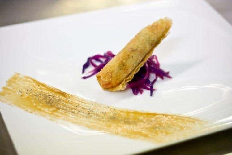 UNA PERLA DELLO CHEF GAMBERO CON PORRO STUFATO AVVOLTO IN PASTA BRICK FRITTO SU INSALATINA DI CAVOLO VIOLA